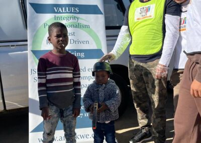 Young-boys-standing-with-the-director-of-Arenkwe-AGS